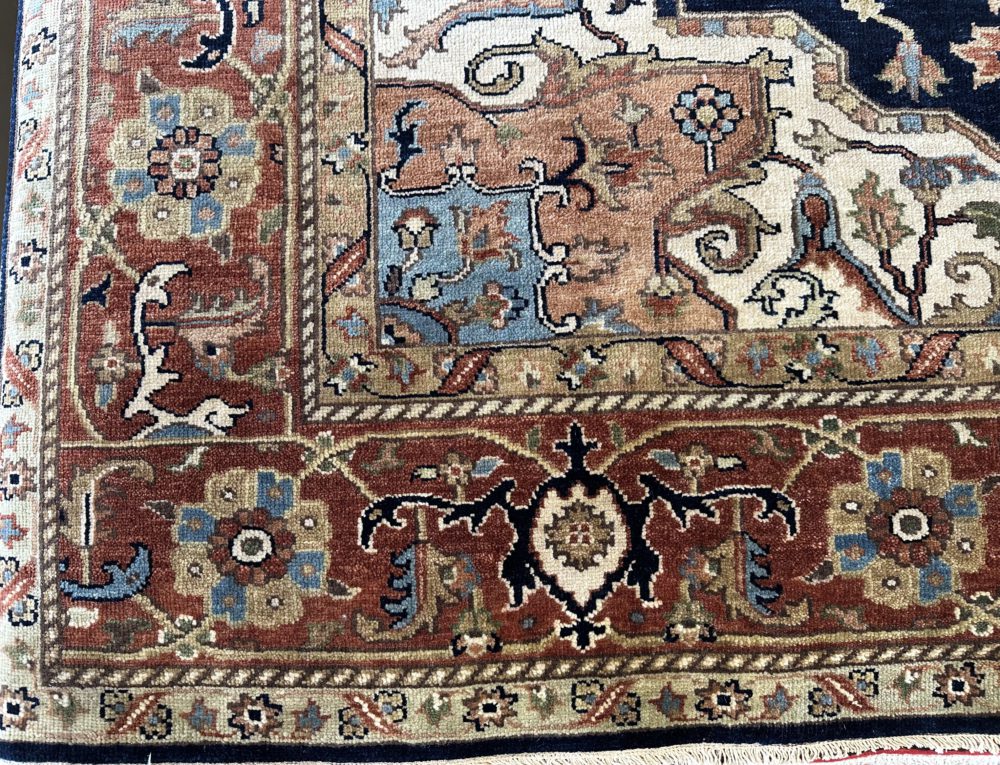 This hand knotted Indo Serapi rug lends a traditional feel to your favorite room. It carries a bold geo-floral design elements along with a pleasing balance of blue, natural and red colors.