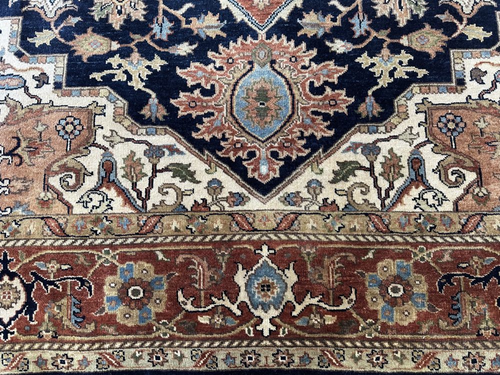 This hand knotted Indo Serapi rug lends a traditional feel to your favorite room. It carries a bold geo-floral design elements along with a pleasing balance of blue, natural and red colors.