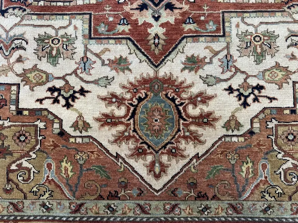 This hand knotted Indo Serapi rug lends a traditional feel to your favorite room. It carries bold geo-floral design elements along with a pleasing balance of soft colors.