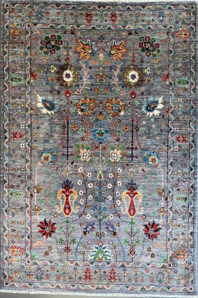 This hand knotted Pakistani rug lends a tribal feel to your favorite room. It carries floral design elements along with a pleasing balance of gray, blue and green colors. ws | Manoukian Rugs™